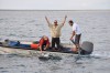 Dudes in a tinny swimming a sailfish to freedom